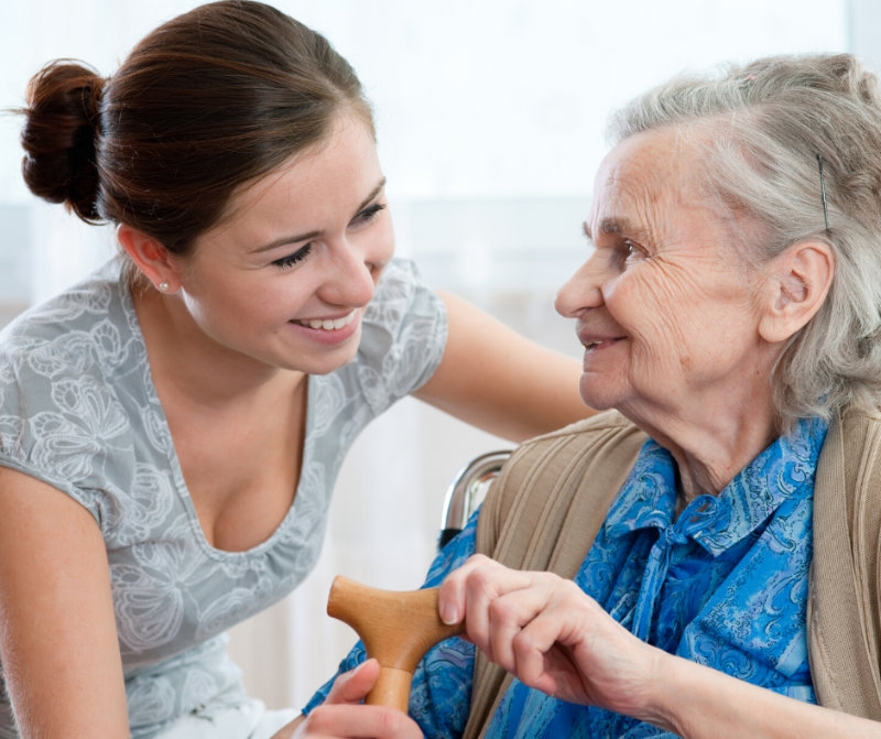 image of a carer helping a senior citizen